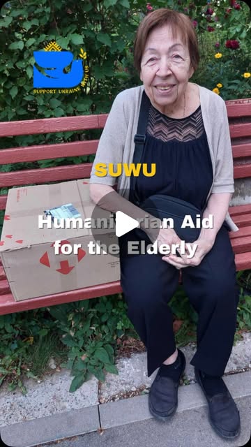 An older Ukrainian woman seated beside a delivered aid box in a Reel preview